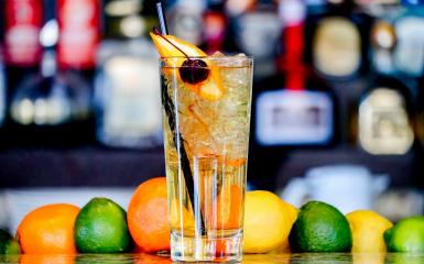 Napój w szklance obok owoce